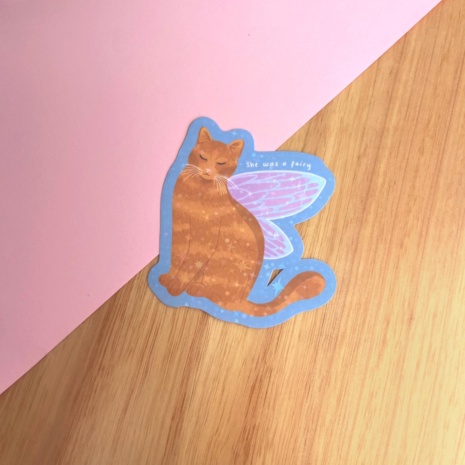 Holographic vinyl sticker featuring a whimsical cat with delicate fairy wings