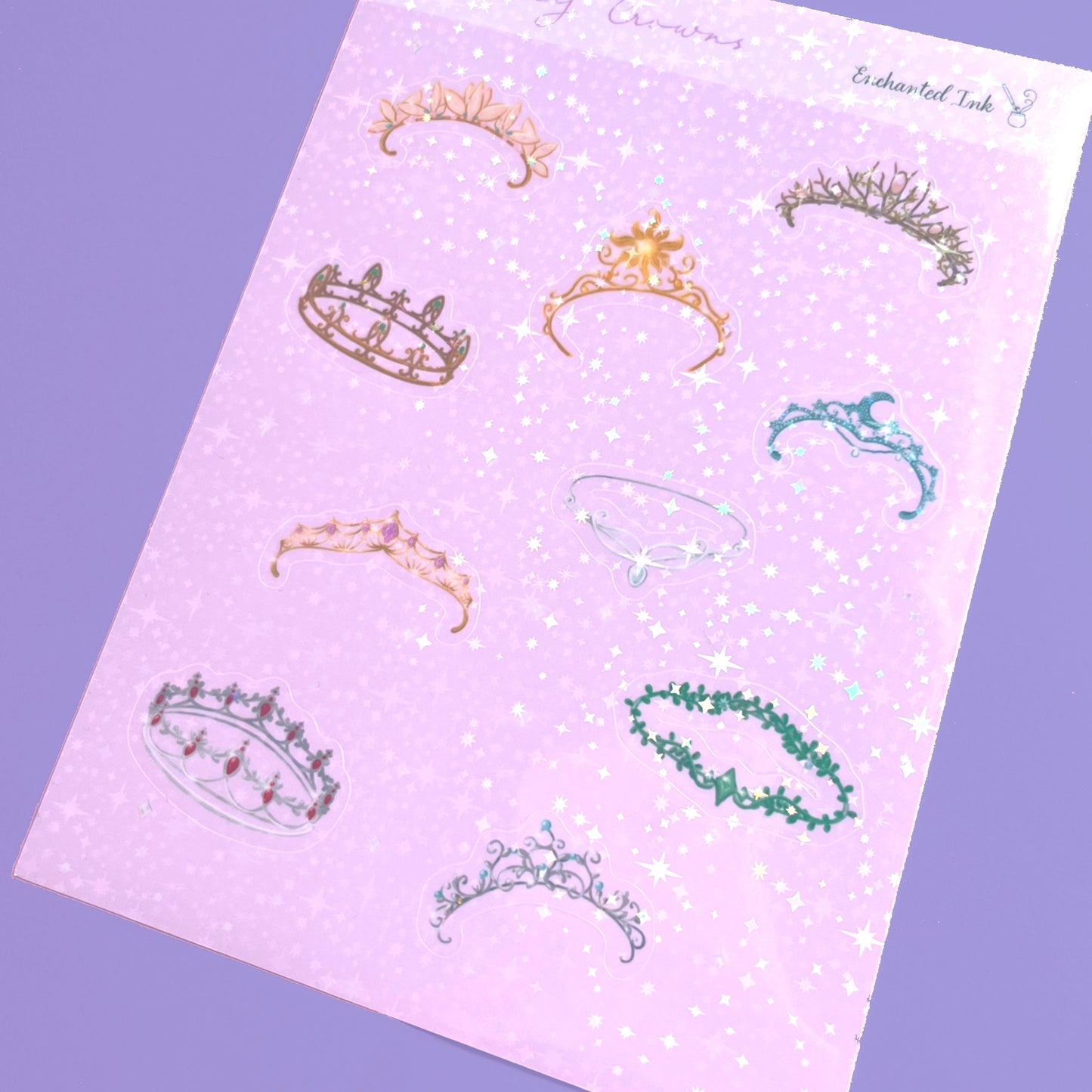 Whimsical holographic sticker sheet featuring fantasy crowns inspired by enchanted kingdoms
