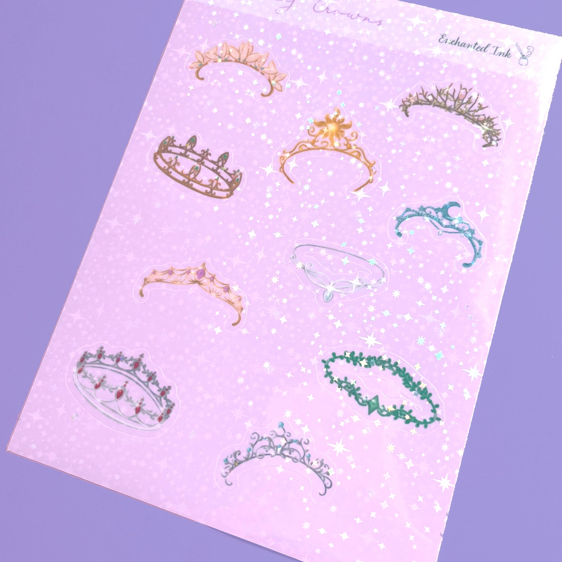 Whimsical holographic sticker sheet featuring fantasy crowns inspired by enchanted kingdoms