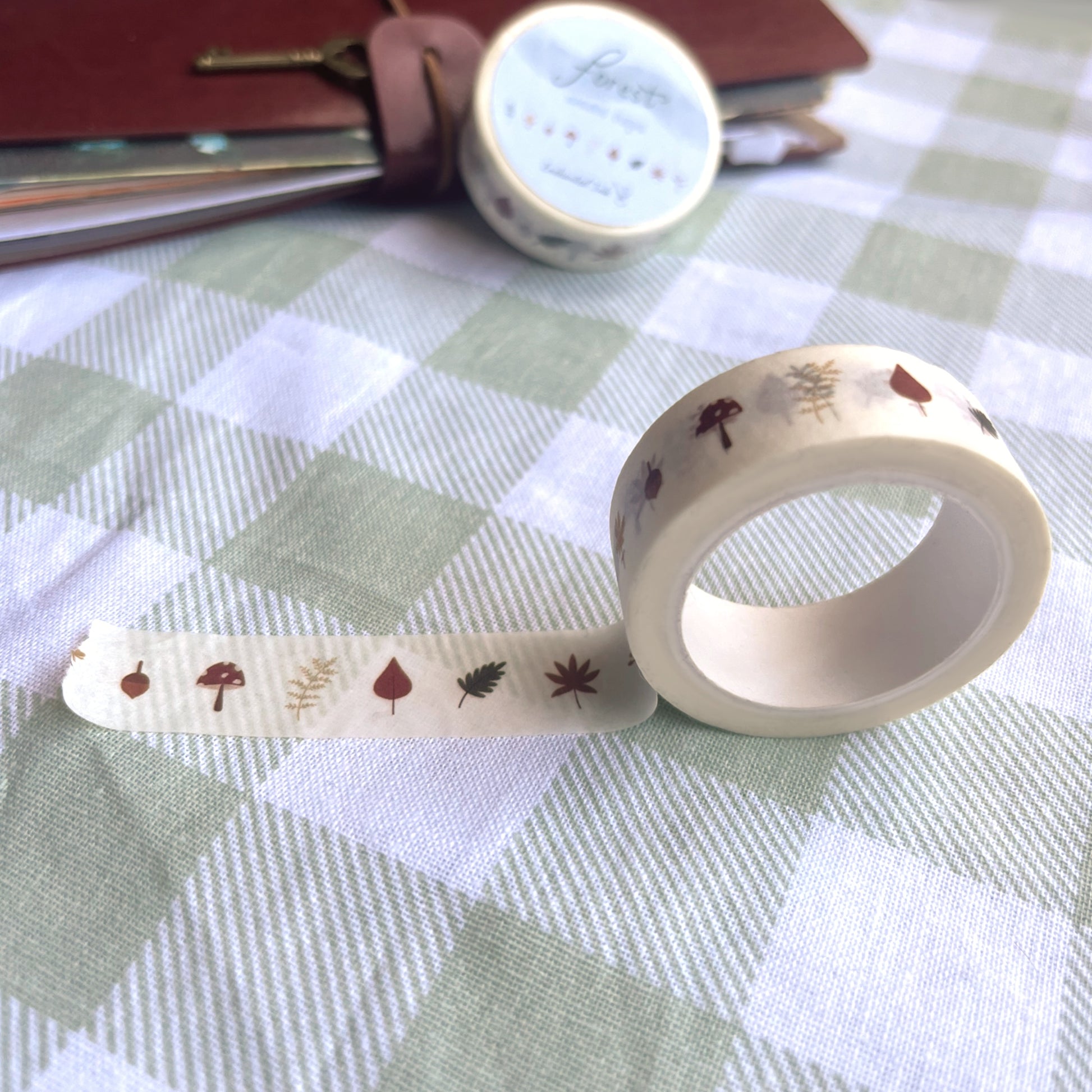 Close-up of forest washi tape showing autumn leaves and greenery